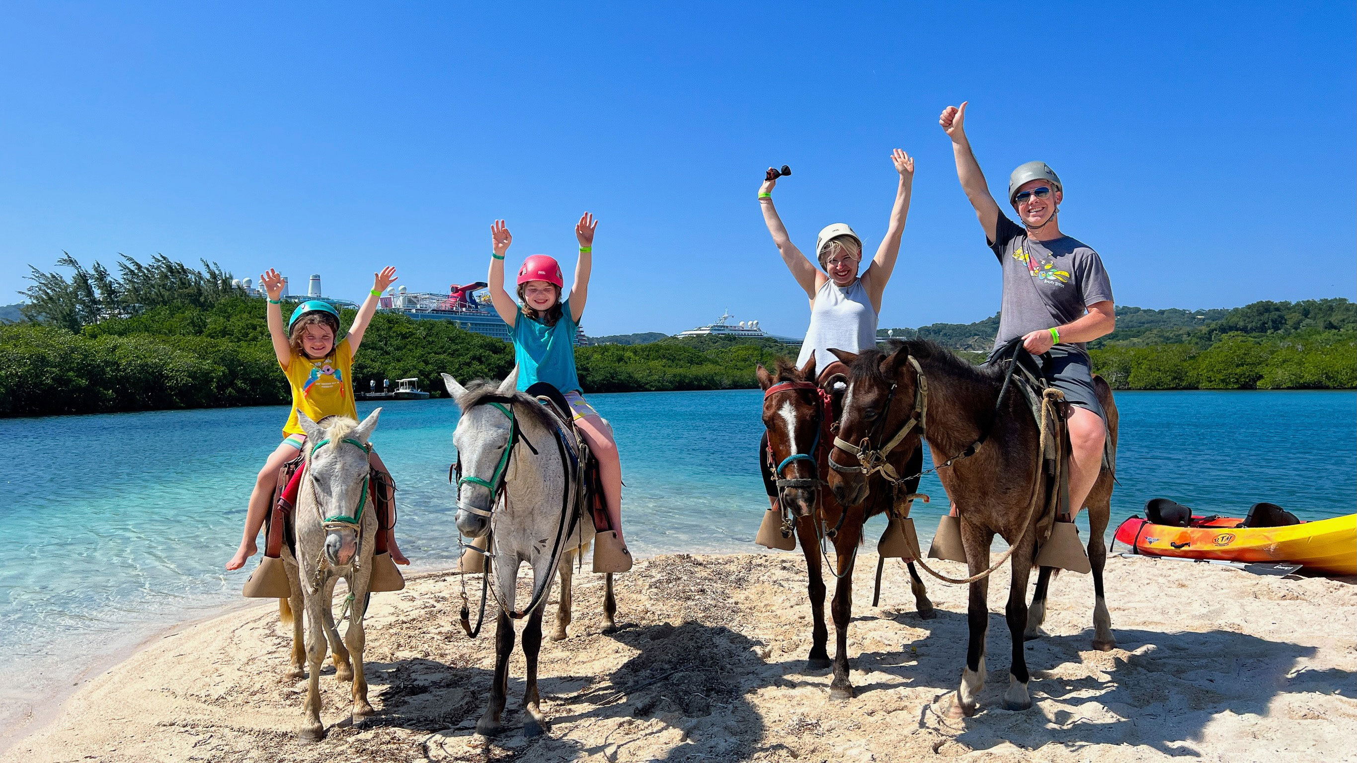 Family on horseback on a Roatan beach after a cruise ship excursion